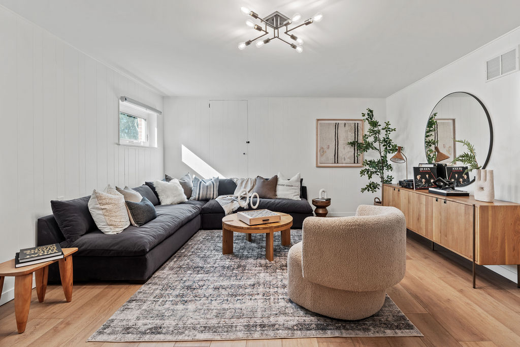 Bright furnished living room with wood floors and modern seating