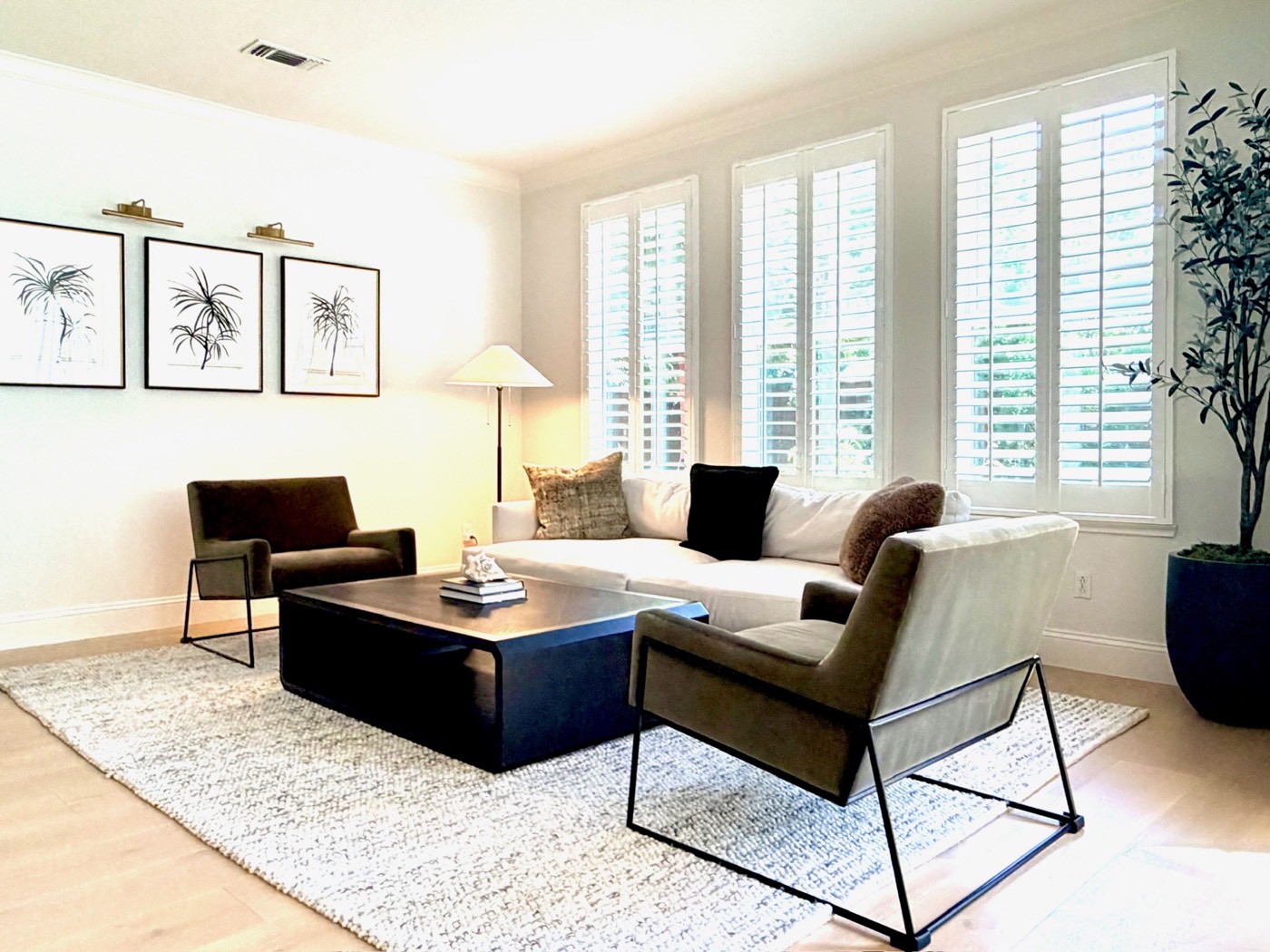 Bright living room with wood flooring, large windows and comfortable seating