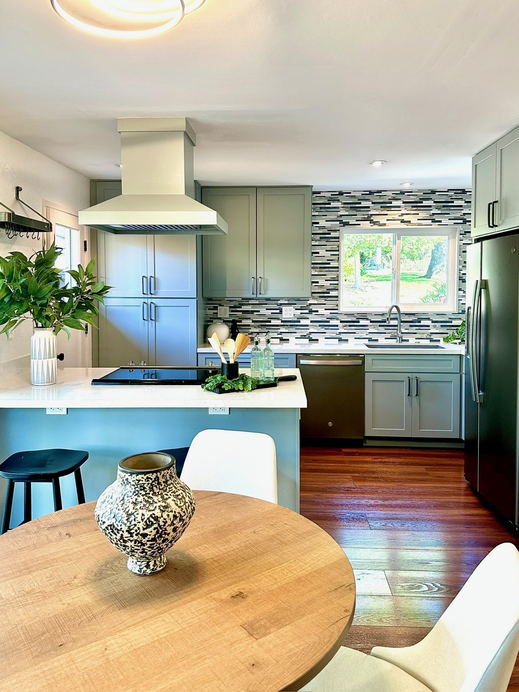 Kitchen and dining area with wood flooring and large window