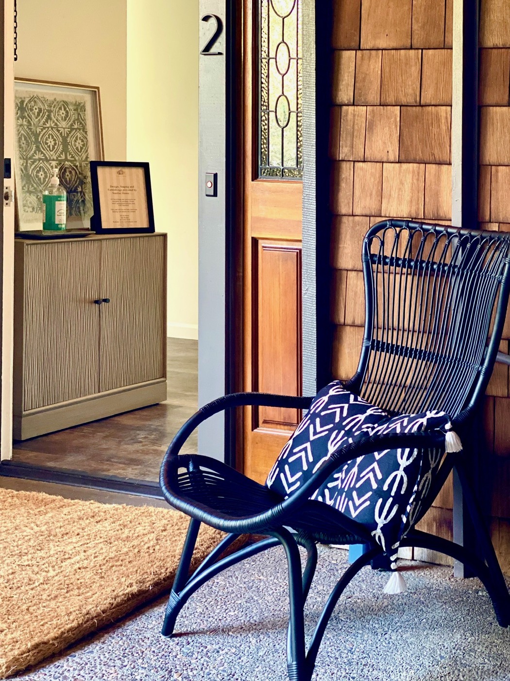 Residential entry detail with wood siding, front door and seating
