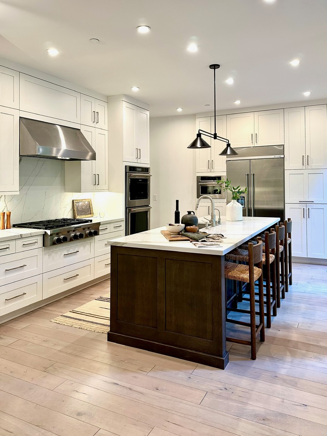 Updated kitchen with island, pendant lighting and light cabinetry