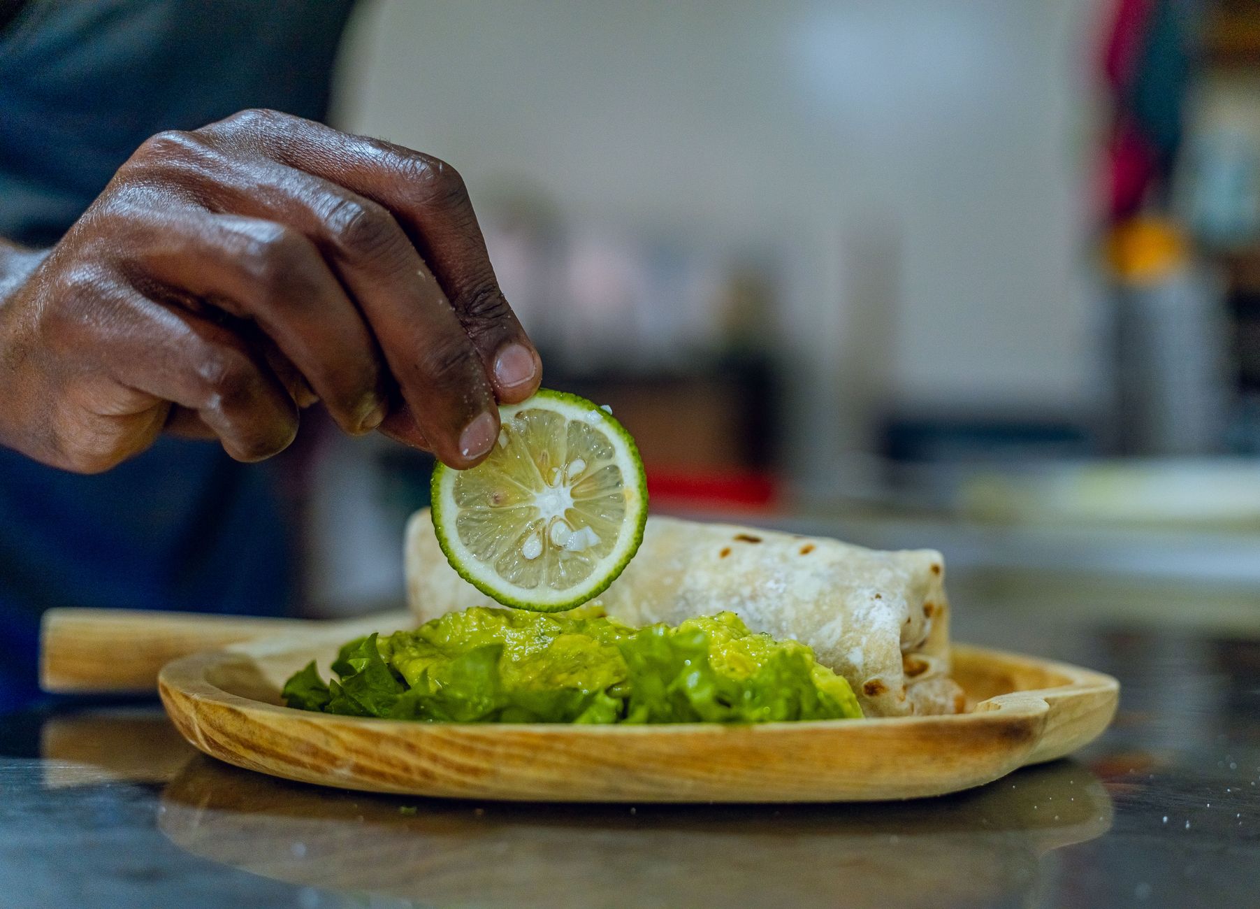 A burrito being garnished