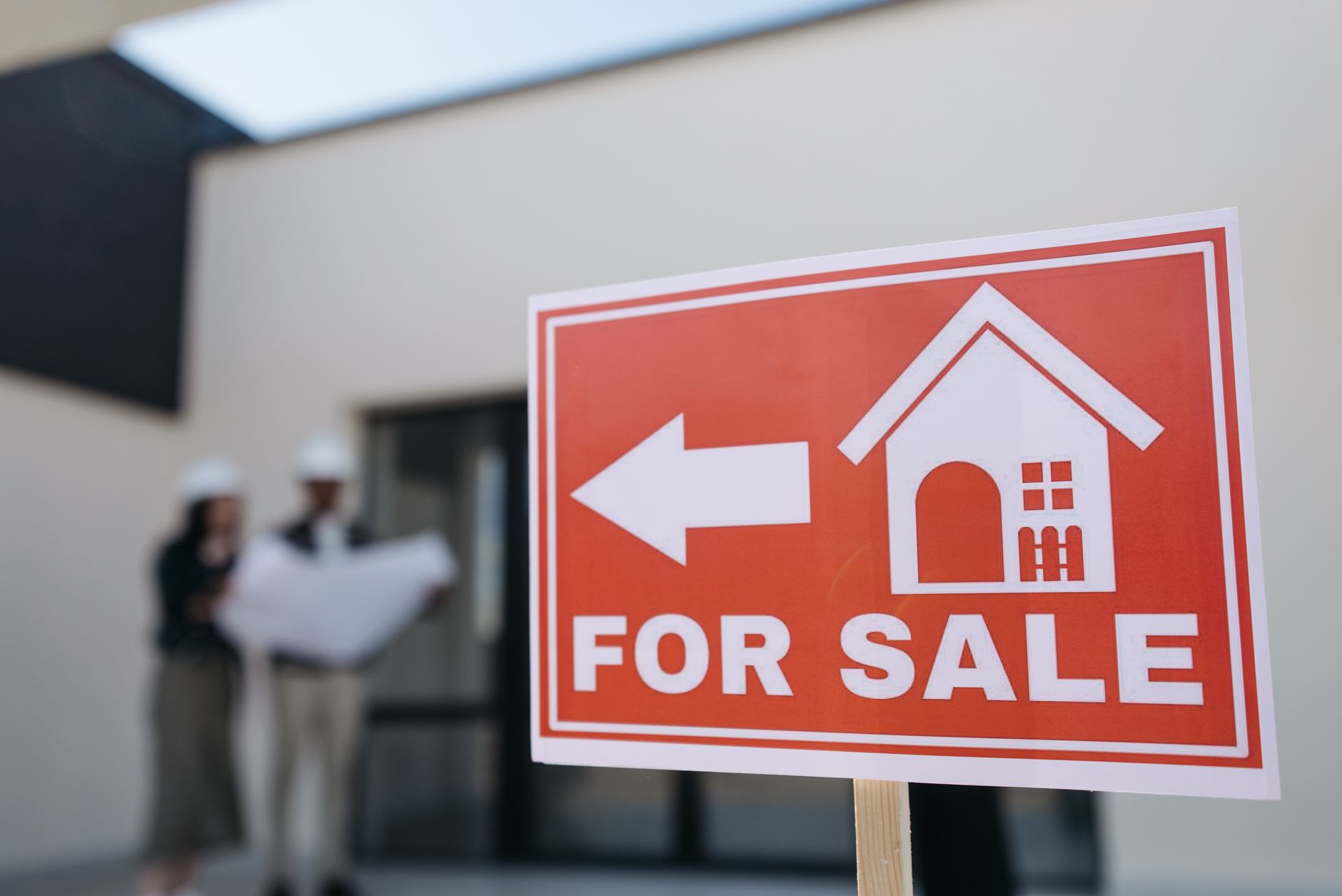 Home for sale sign in front of a house